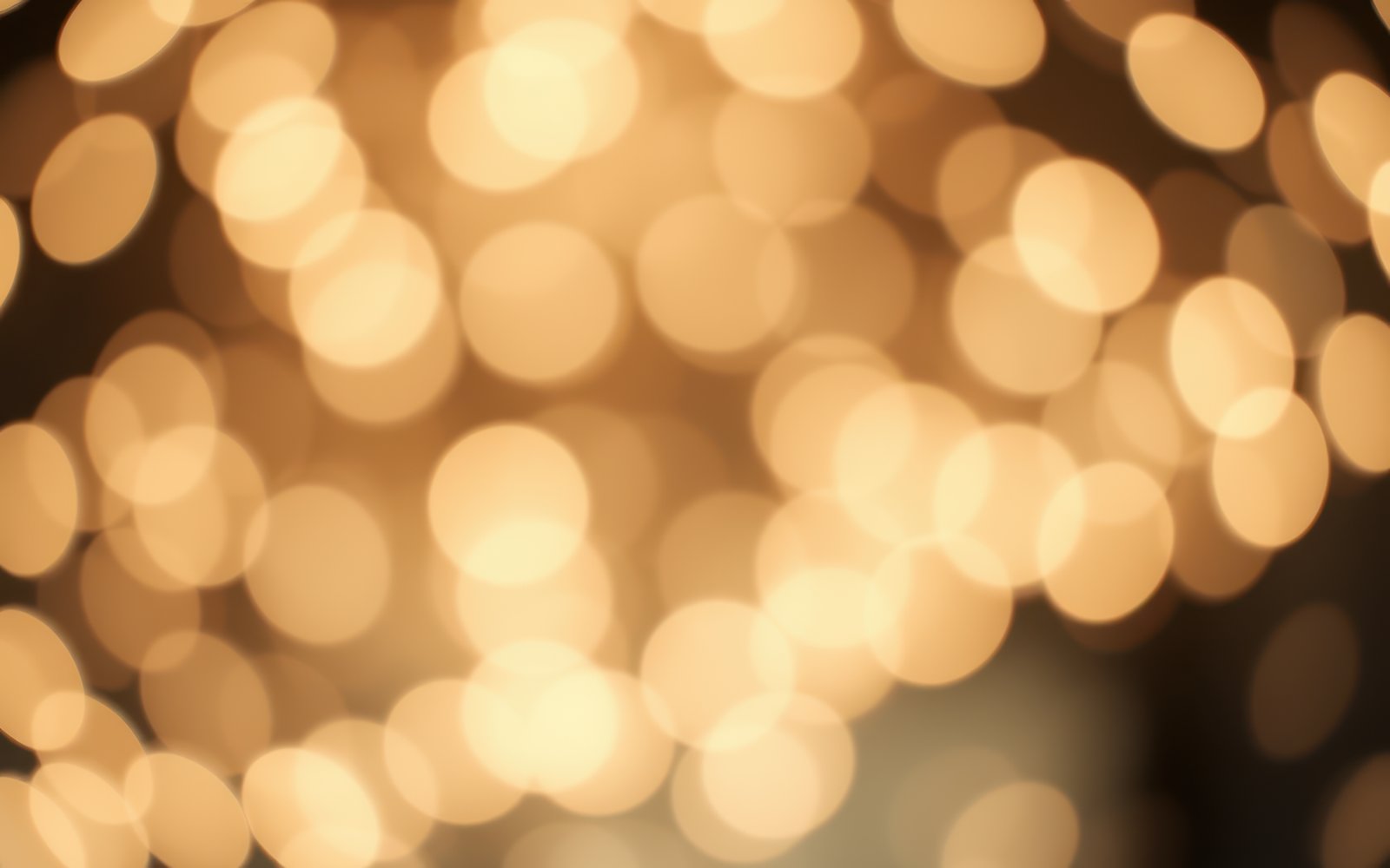 Golden bokeh lights create a warm and inviting atmosphere in a cozy setting during an evening gathering